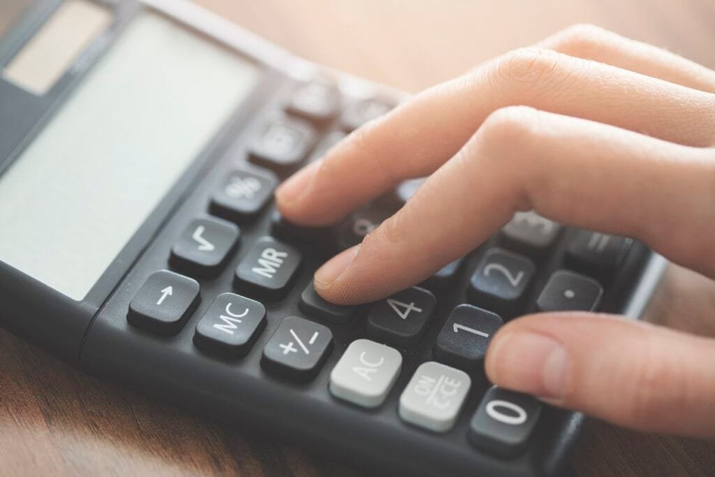 Hand using calculator on the table Calculator cbd